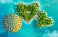 Tropical islands in the form of two hearts and flying hot air balloon