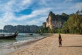Tropical islands with woman tourist looking at sea on white sand beach at Railay Beach, Krabi Thailand