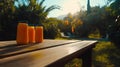 Tropical juice bottles on outdoor table at sunset Royalty Free Stock Photo