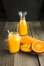 Tropical juice of mango, orange, banans fruit in jar with straw on wooden board. Royalty Free Stock Photo