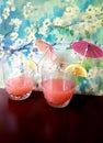 Tropical juice served with lime, lemon and drink parasol Royalty Free Stock Photo