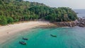 Tropical lagoon in ocean with boats near beautiful beach and palm trees Royalty Free Stock Photo