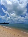 Tropical landscape. Blue sky, white clouds, beach, warm ocean and waves.