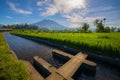 Tropical landscape during sunrise. Scenic view to Agung Volcano. River and rice fields in the village. Bali, Indonesia Royalty Free Stock Photo