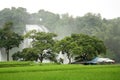 Tropical landscape with waterfall and house Royalty Free Stock Photo