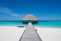 Tropical landscape with wooden bridge and house on the water at Maldives Royalty Free Stock Photo