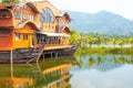 Tropical landscape. Wooden house in the form of a boat on the ocean with a view of the mountains. Travel and tourism in Asia