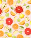 Tropical layout with fresh citrus fruits and apples on pale pink background Royalty Free Stock Photo