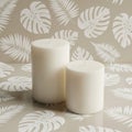Tropical leaf background with white candles Royalty Free Stock Photo