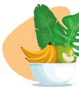 Tropical leaves and bowl with apple and bananas