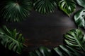 Tropical leaves and an empty circular wooden table on a dark background