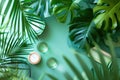 Tropical leaves and glass jars on green