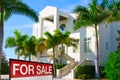 Tropical luxury mansion house w SOLD sign and palm trees Royalty Free Stock Photo