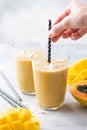 Tropical mango coconut smoothie in a glass Royalty Free Stock Photo