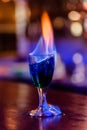 Beautiful cocktail burning with fire on the bar table Royalty Free Stock Photo