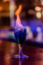 Tropical night cocktail burning with fire at the bar table Royalty Free Stock Photo