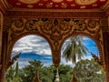 A tropical oasis viewed through a temples arched windows.