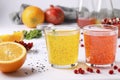 Tropical orange and pomegranate juice with basil seeds or falooda seeds or tukmaria in glasses and bottles on white background, Royalty Free Stock Photo