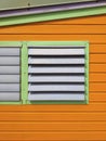 Tropical orange window and facade background. Caribbean colorful architecture detail