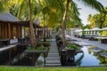 Tropical outdoors restaurant setup with tables in water surrounded by palm trees at Maldives Royalty Free Stock Photo