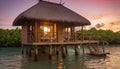 Tropical overwater bungalow at sunset Royalty Free Stock Photo