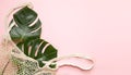 Tropical palm tree leaf and eco bag on a pink background. Vibrant minimal fashion concept Royalty Free Stock Photo