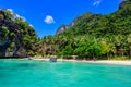 Tropical Papaya beach at paradise coast, El Nido, Palawan, Philippines. Tour A Route. Coral reef and sharp limestone cliffs