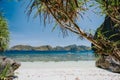 Tropical paradise beach on Entalula Island. Blue lagoon surrounds by karst limestone rocky mountains Royalty Free Stock Photo