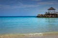 Tropical paradise: caribbean beach with pier and gazebo, Montego Bay, Jamaica Royalty Free Stock Photo