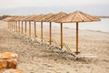 Tropical parasols on empty Maleme beach Royalty Free Stock Photo