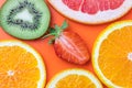 Tropical pattern, texture with exotic citrus fruit, food background. Slices of grapefruit, strawberry, kiwi and tangerine. Fun Royalty Free Stock Photo
