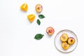 Tropical peach and orange fruits for fresh juice on plates white background top view space for text