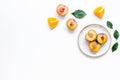 Tropical peach and orange fruits for fresh juice on plates white background top view space for text