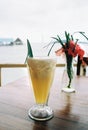 Tropical pineapple smoothie on a wooden table