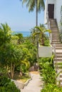 Tropical quiet private resort villa on hill with fresh lush tropical greenery, palms and plants in garden Royalty Free Stock Photo