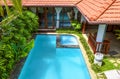 Tropical residential house, scenic backyard with garden and swimming pool Royalty Free Stock Photo