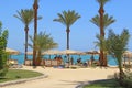 Tropical resort in Egypt. People swimming in sea. Tourists relax on beach Royalty Free Stock Photo