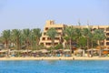 Tropical resort in Egypt. People swimming in sea. Tourists relax on beach Royalty Free Stock Photo