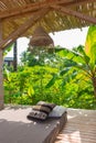 Tropical resort with lounge place with pillows. Holiday villa with garden and comfortable patio. Empty exotic resort.