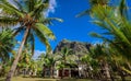 Tropical Resort With Palm Trees & Mountain in Background Royalty Free Stock Photo