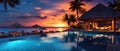 Tropical resort pool and huts at sunset. 21 to 9 aspect ratio Royalty Free Stock Photo
