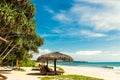 Tropical resort view, sunbeds and umbrellas on ocean beach, Sri Lanka