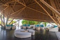 Tropical restaurant interior with sofas and pillows under wooden roof Royalty Free Stock Photo