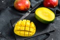 Tropical ripe mango fruit. Black background. Top view Royalty Free Stock Photo