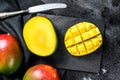 Tropical ripe mango fruit. Black background. Top view Royalty Free Stock Photo