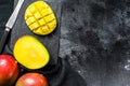 Tropical ripe mango fruit. Black background. Top view. Copy space Royalty Free Stock Photo