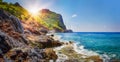 Tropical rocky beach on sunny summer day in Alanya, Turkey. Sea and mountains landscape with waves. Royalty Free Stock Photo