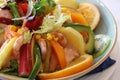 Tropical salad with fruits, prawns, cocktail sauce, kiwi, orange slices and sweet corn Royalty Free Stock Photo