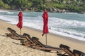 Tropical sand beach with wooden deck chairs and umbrellas near sea on a sunny day. Nature concept. Thailand Royalty Free Stock Photo