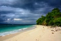 Tropical sandy beach with a dramatic sky before a storm Royalty Free Stock Photo